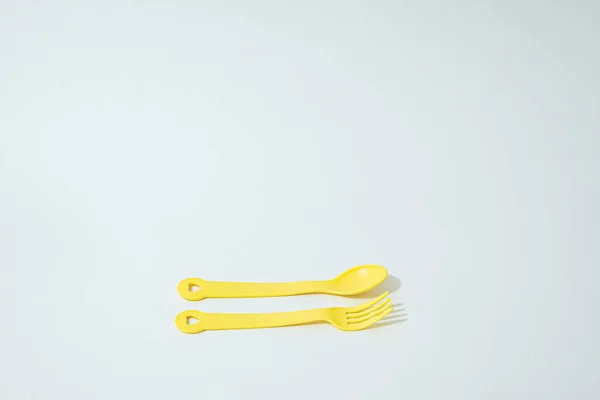 Yellow Children Plastic Spoon Fork White Background — Stock Photo, Image