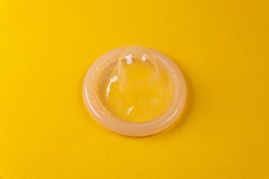 Sarı arka planda lateks prezervatif