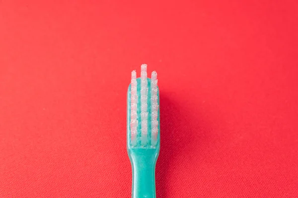 Green Toothbrush Red Background — Stock Photo, Image