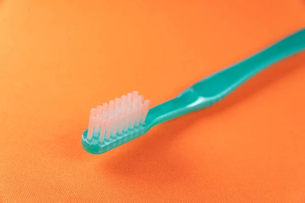 Green Toothbrush Orange Background — Stock Photo, Image