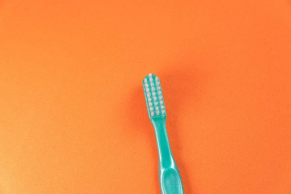 Green Toothbrush Orange Background — Stock Photo, Image