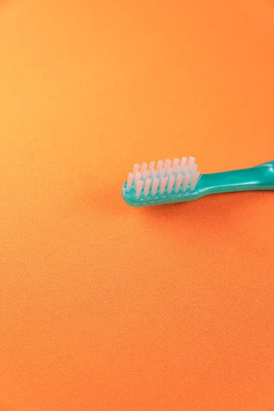 Green Toothbrush Orange Background — Stock Photo, Image