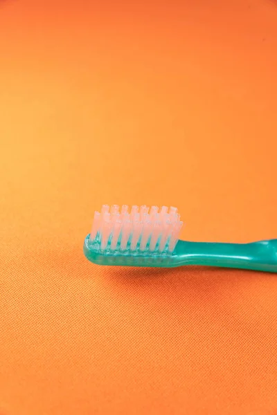 Green Toothbrush Orange Background — Stock Photo, Image