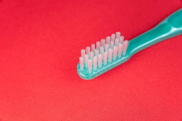 Green Toothbrush Red Background — Stock Photo, Image