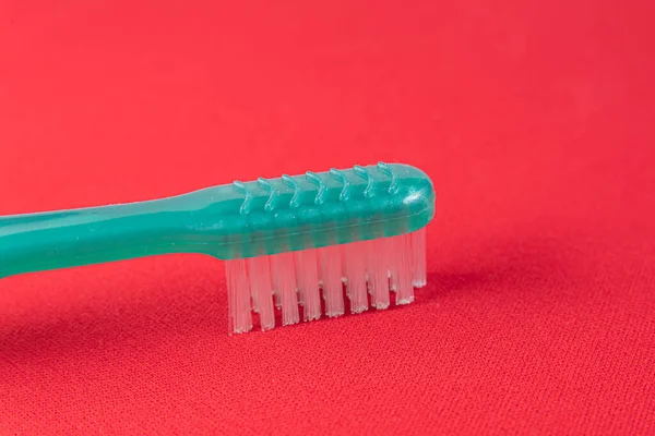 Green Toothbrush Red Background — Stock Photo, Image