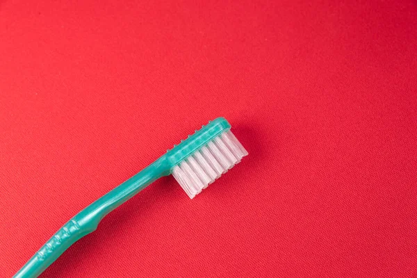 Green Toothbrush Red Background — Stock Photo, Image