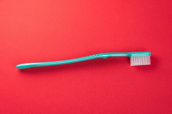 Green Toothbrush Red Background — Stock Photo, Image