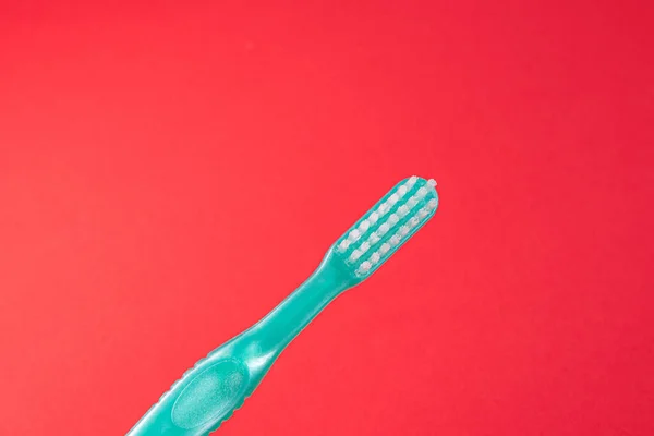 Green Toothbrush Red Background — Stock Photo, Image