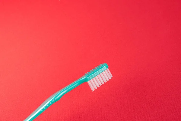 Green Toothbrush Red Background — Stock Photo, Image