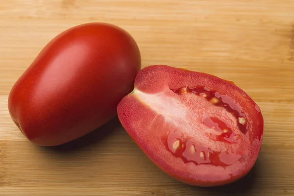 Red ripe tomato. Red ripe black tomato on the background. Close-up. Side view.A tomato.