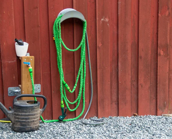 Green Flexible Water Hose Black Watering Can Front Stock Image
