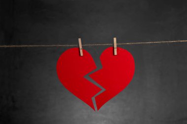 SV. Valentine's arka plan. Kırık kalp ip kopya alanı ile koyu arka plan üzerinde asılı.