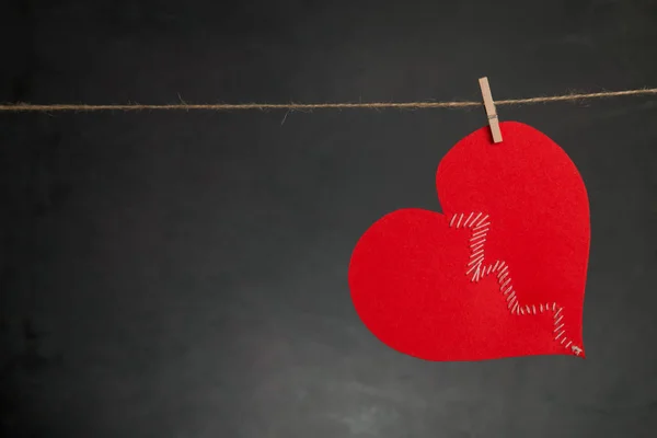 SV. Valentine's arka plan. Kırık kalbini ip kopya alanı ile koyu arka plan üzerinde asılı dikilmektedir.