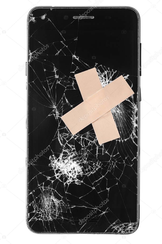 Broken mobile phone / cellphone / smartphone screen with medical patch stitches isolated on white background