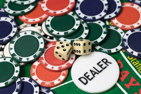 Casino chips and dice on green card game table. Gambling background