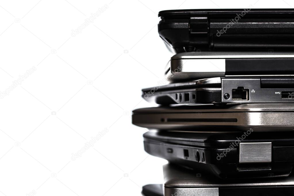 Stack of laptops / notebooks with copy space isolated on white background