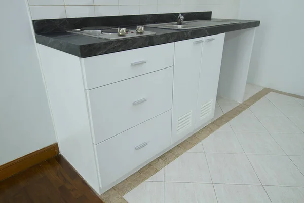 White Wooden Cabinet Black Counter Top Stock Picture