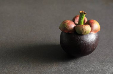 Siyah arka planda sökülmüş mangosteen meyvesi (Garcinia mangostana).