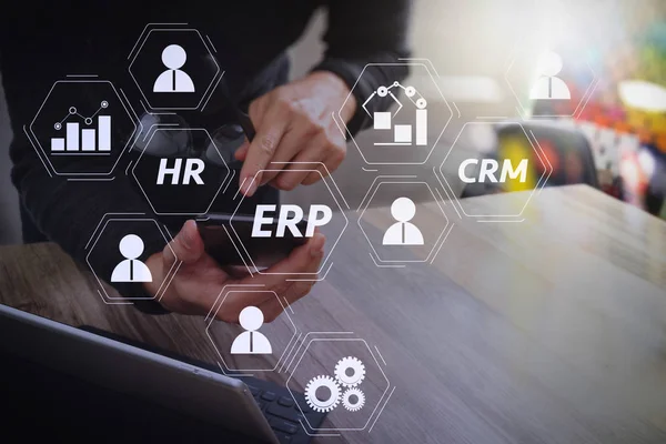 Architecture of ERP (Enterprise Resource Planning) system with connections between business intelligence (BI), production, CRM modules and HR diagram.Businessman hand using mobile payments online shopping.