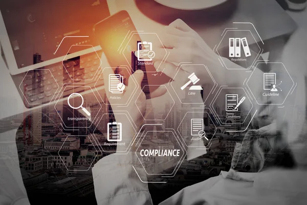 Compliance Virtual Diagram for regulations, law, standards, requirements and audit.hand using smart phone and digital tablet computer for online banking payment communication in modern office.