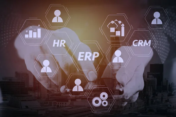 Architecture of ERP (Enterprise Resource Planning) system with connections between business intelligence (BI), production, CRM modules and HR diagram.businessman hand working with mobile phone.