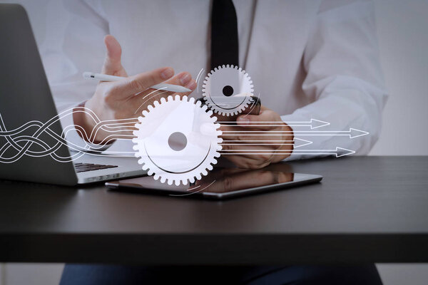 Thinking about structuring virtual diagram of business process with solutions. businessman working with smart phone on wooden desk in modern office 