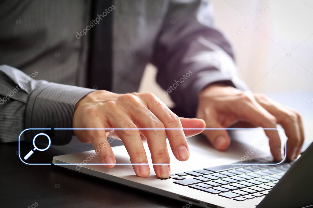 Searching Browsing Internet Data Information Networking Concept with blank search bar.close up of businessman working with laptop computer on wooden desk in modern office 