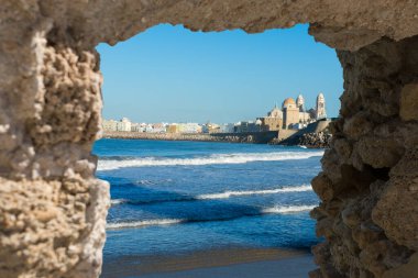                             View at Cadiz, old historical town, through stone  ruined wall, Andalusia, Spain. clipart