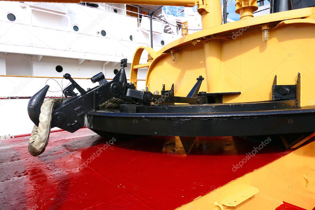 Tugboat pulling hook and rope situated at the stern of the ship