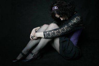 Young cute elegant oldfashioned lady sitting on the floor