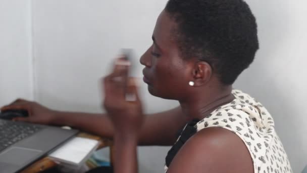 Young Woman Working Laptop While Phoning — Stock Video