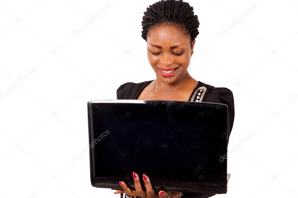 Young businesswoman standing working on laptop, isolated on white