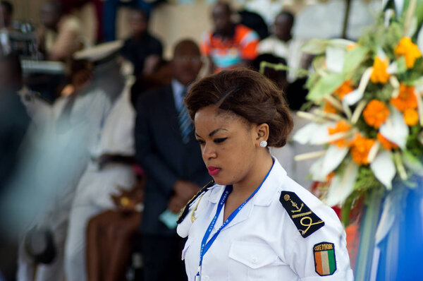 Abidjan, Ivory Coast - August 3, 2017: Epaulets ceremony for students leaving the Maritime Academy. a hostess of the standing navy watching over the security