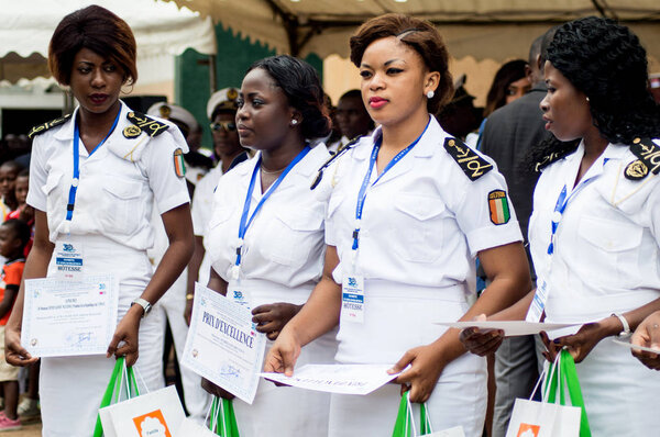 Abidjan, Ivory Coast - August 3, 2017: Epaulette and graduation ceremony for students leaving the Maritime Academy. group of marine women dressed in white and holding diplomas