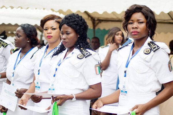 Abidjan, Ivory Coast - August 3, 2017: Epaulette and graduation ceremony for students leaving the Maritime Academy. group of marine women dressed in white and holding diplomas