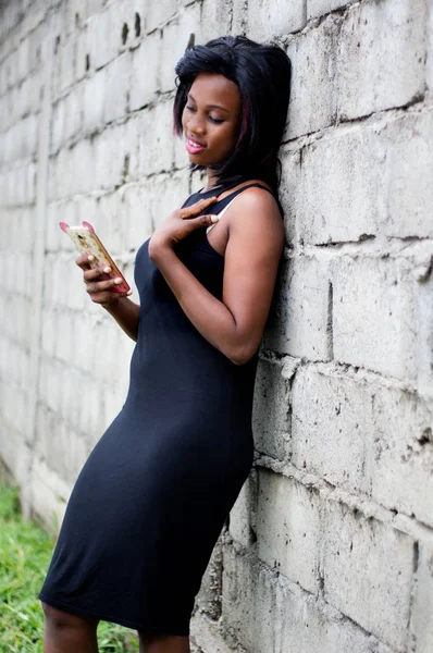 Girl Using Mobile Phone Standing Brick Wall — Stock Photo, Image