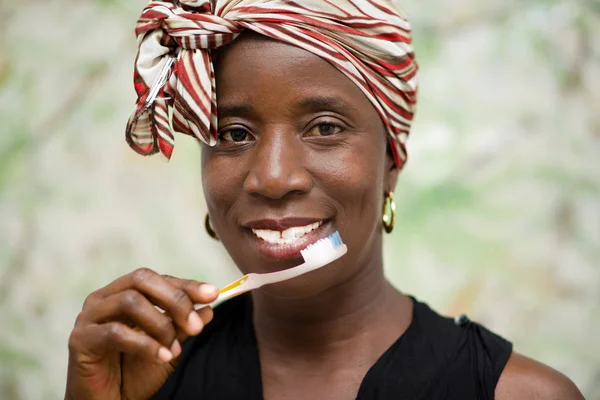 Portrait of young woman with a toothbrush — Stock Photo, Image