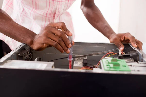 a computer expert repairs a computer