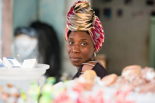 Ritratto di donna venditrice seduta dietro il suo stand di caramelle — Foto Stock