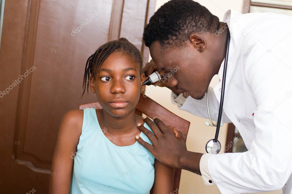 doctor consults the ears of his patient.