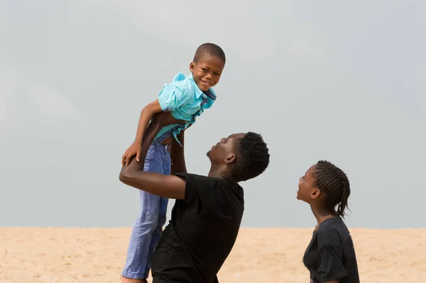 Young man at the beach with his family — Stock Photo, Image