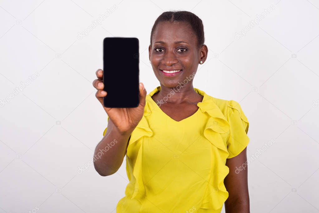 Young woman showing mobile phone screen