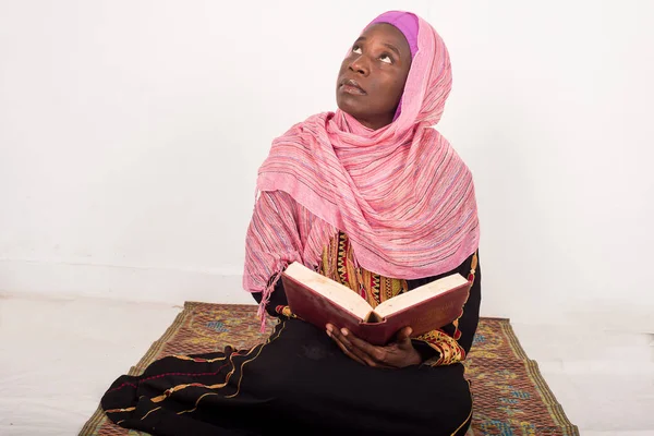 Mulher muçulmana sentada orando lê o Alcorão — Fotografia de Stock