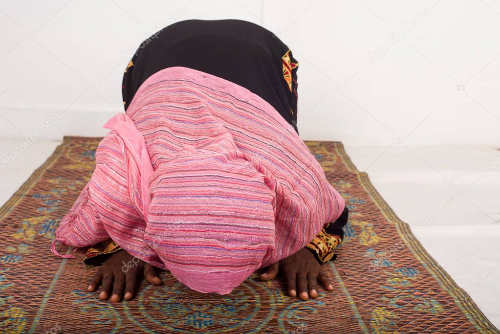 Muslim woman praying in the mosque during Ramadan