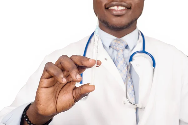 male doctor standing in glasses with stethoscope on the neck and smiling syringe, ready to give medical treatment to the patient.
