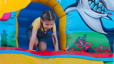 4 year old girl playing on an outdoor trampoline. High quality photo