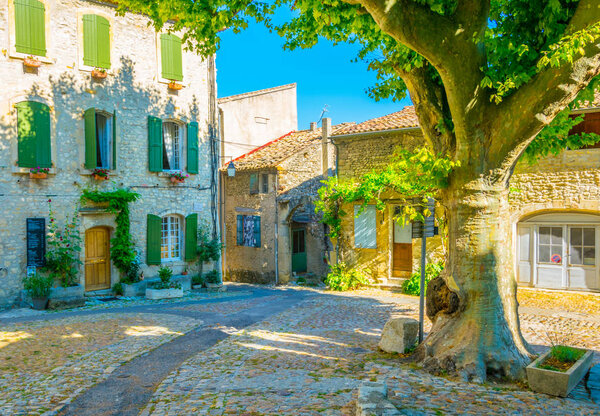 A narrow street in the old town of Vaison-la-Romaine in Franc