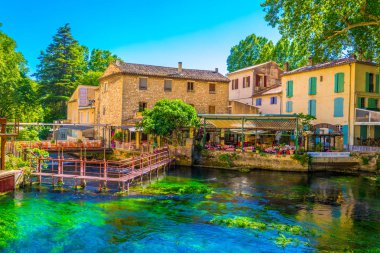 FONTAINE DE VAUCLUSE, FRANCE, JUNE 24, 2017: Riverside promanede at Fontaine de Vaucluse in Franc