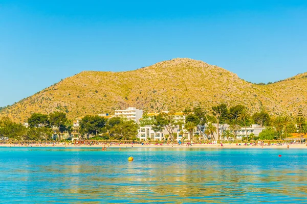 Holiday resorts stretched alongside Alcudia beach on Mallorca, Spai