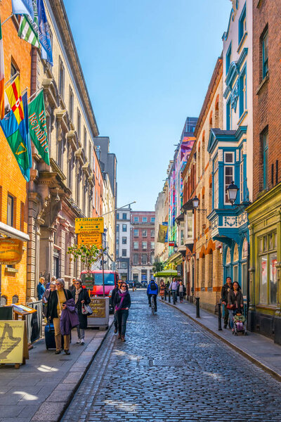 DUBLIN, IRELAND, MAY 9, 2017: People are strolling through a busy street in the Temple bar district of Dublin, Ireland
